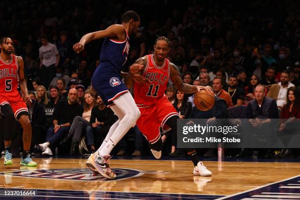 DeMar DeRozan of the Chicago Bulls drives to the net against Kevin Durant of the Brooklyn Nets at Barclays Center on December 04, 2021 in New York...