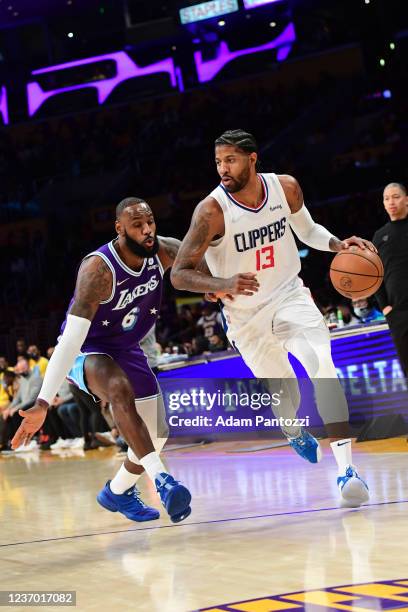 Paul George of the LA Clippers drives to the basket against LeBron James of the Los Angeles Lakers during the game on December 3, 2021 at STAPLES...