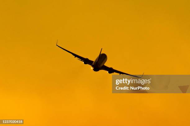 Aircraft silhouette symbol photo during magic hour. Dusk and sunset golden hour with warm sky colors at Amsterdam Schiphol AMS EHAM International...