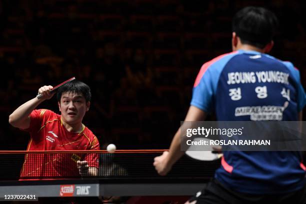 China's Fan Zhendong plays a shot against South Korea's Jeoung Young-sik during their World Table Tennis Cup Finals men's quarter-finals singles...