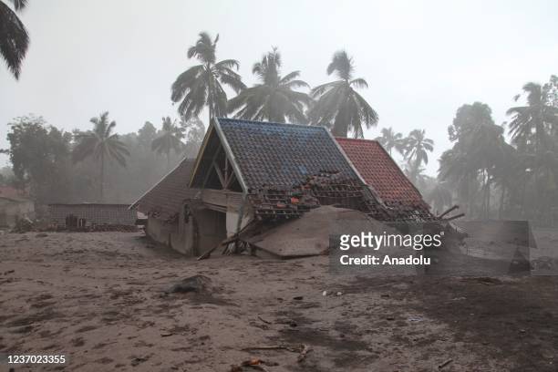 Number of officers inspect houses damaged at the Sumberwuluh village following the eruption of Mount Semeru volcano in Lumajang regency, East Java...
