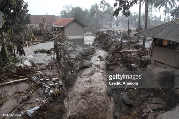 Number of officers inspect houses damaged at the Sumberwuluh village following the eruption of Mount Semeru volcano in Lumajang regency, East Java...