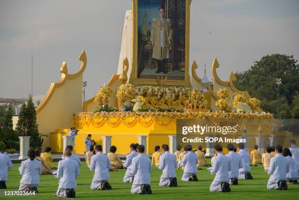 Thai government officials pay respect in front of a large portrait of the late Thai King Bhumibol Adulyadej during the ceremony in remembrance of his...