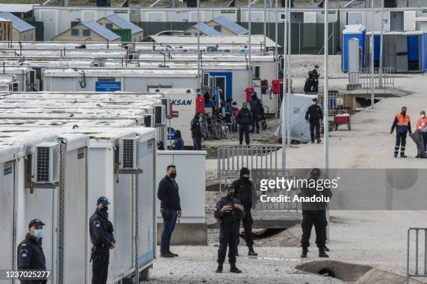 Security stand in the camp as Pope Francis delivers a speech during a meeting with refugees at the Reception and Identification Centre in Mytilene on...