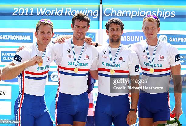 Matthew Langridge, Richard Egington, Tom James and Alex Gregory of Great Britain celebrate with their gold medals after winning the Men's Four final...