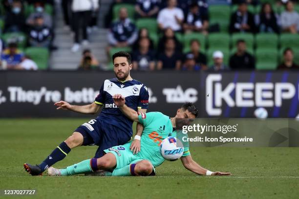 Stefan Nigro of Melbourne Victory and Bruno Fornaroli of Perth Glory fall during the round 3 A-League soccer match between Melbourne Victory and...