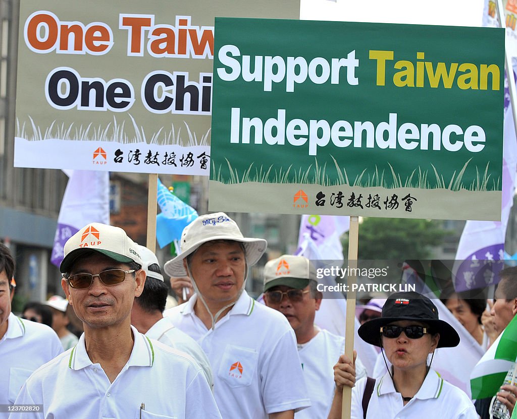 Anti-China activists hold placards durin