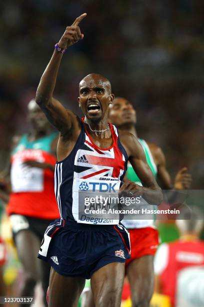 Mohamed Farah of Great Britain celebrates as he crosses the finish line to claim victory in the men's 5000 metres final during day nine of 13th IAAF...