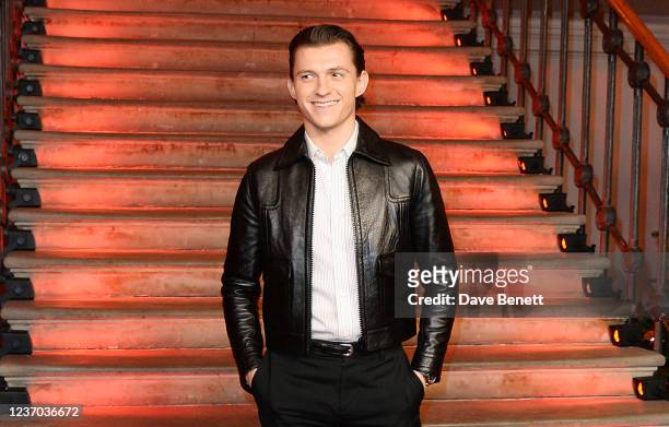 Tom Holland poses at a photocall for "Spider-Man: No Way Home" at The Old Sessions House on December 5, 2021 in London, England.