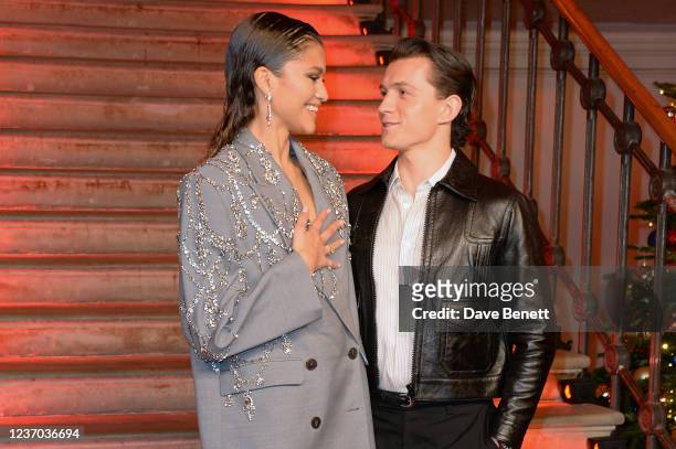Zendaya and Tom Holland pose at a photocall for "Spider-Man: No Way Home" at The Old Sessions House on December 5, 2021 in London, England.