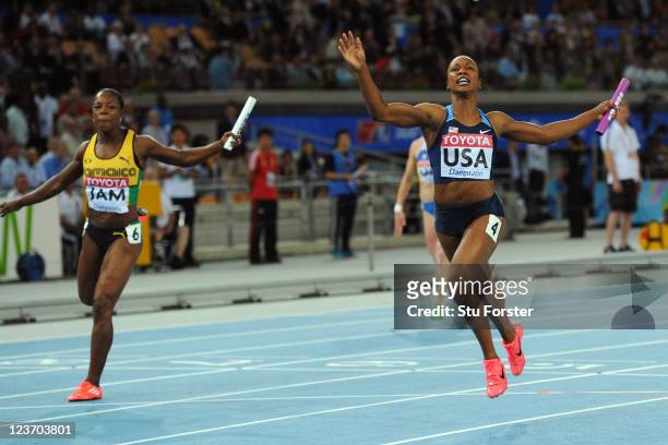 Carmelita Jeter of the USA crosses the finish line to claim victory ahead of Veronica Campbell-Brown of Jamaica in the women's 4x100 metres final...