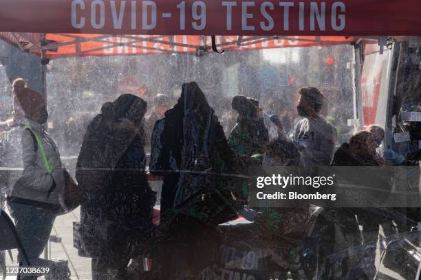 Residents wait in line at a Covid-19 mobile testing site in the Times Square neighborhood of New York, U.S., on Sunday, Dec. 5, 2021. Five months...