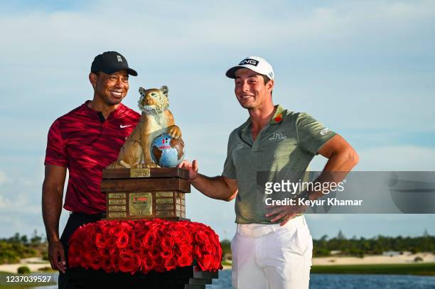 Tournament host Tiger Woods and Viktor Hovland of Norway smile during the trophy ceremony following Hovlands victory in the final round of the Hero...
