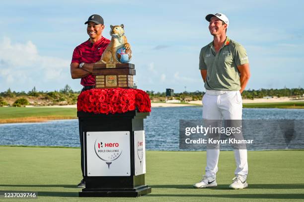 Tournament host Tiger Woods and Viktor Hovland of Norway smile during the trophy ceremony following Hovlands victory in the final round of the Hero...