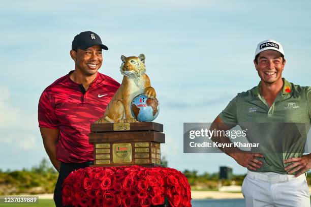 Tournament host Tiger Woods smiles with Viktor Hovland of Norway during the trophy ceremony following Hovlands victory in the final round of the Hero...