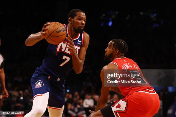 Kevin Durant of the Brooklyn Nets in action against Derrick Jones Jr. #5 of the Chicago Bulls at Barclays Center on December 04, 2021 in New York...