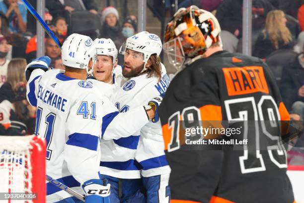 Corey Perry of the Tampa Bay Lightning celebrates with Pierre-Edouard Bellemare and Pat Maroon after scoring a goal against Carter Hart of the...