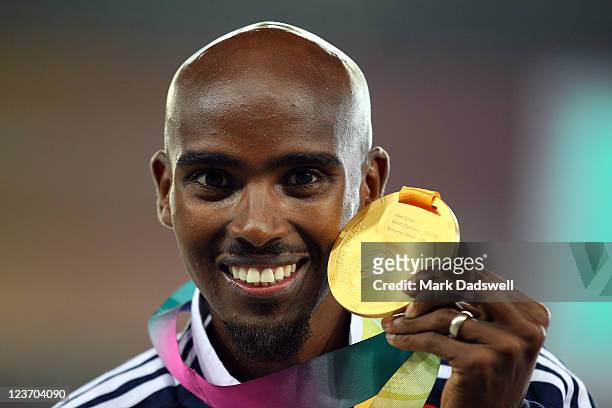 Mohamed Farah of Great Britain celebrates with his gold medal during the medal ceremony for the men's 5000 metres final during day nine of 13th IAAF...