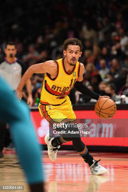 Trae Young of the Atlanta Hawks dribbles during the game against the Charlotte Hornets on December 5, 2021 at State Farm Arena in Atlanta, Georgia....
