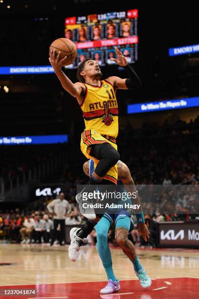 Trae Young of the Atlanta Hawks dunks the ball during the game against the Charlotte Hornets on December 5, 2021 at State Farm Arena in Atlanta,...