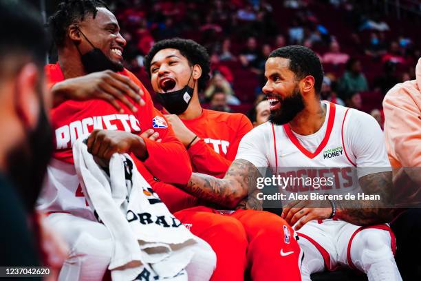 Danuel House Jr. #4 , Daishen Nix and D.J. Augustin of the Houston Rockets laugh on the bench after Augustin had his shot blocked during the game...