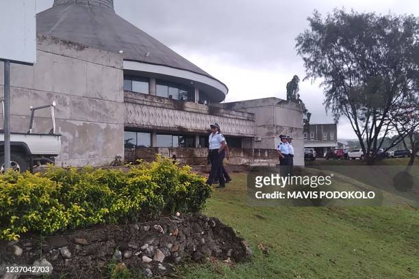 Police stand guard outside parliament on December 6, 2021 as Solomon Islands embattled Prime Minister Manasseh Sogavare faces a no-confidence vote,...