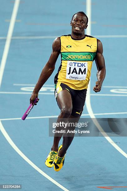 Usain Bolt of Jamaica celebrates victory and a new world record in the men's 4x100 metres relay final during day nine of 13th IAAF World Athletics...