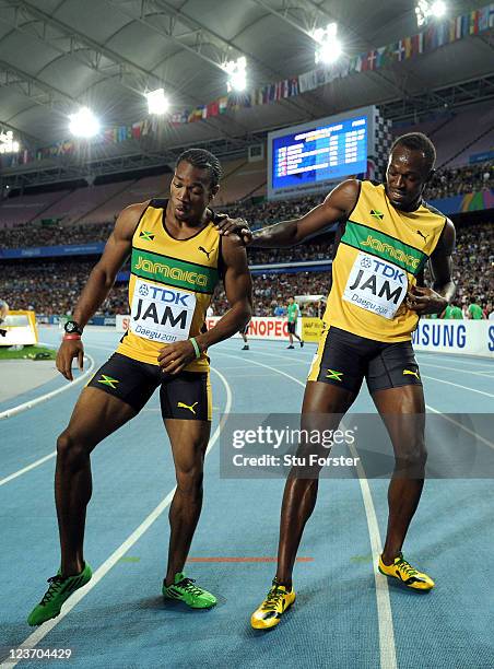 Yohan Blake and Usain Bolt of Jamaica celebrate victory and a new world record in the men's 4x100 metres relay final during day nine of 13th IAAF...