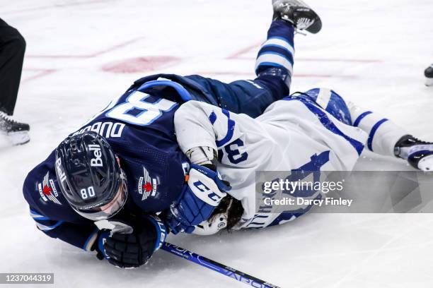 Pierre-Luc Dubois of the Winnipeg Jets gets tangled up with Auston Matthews of the Toronto Maple Leafs during third period action at the Canada Life...