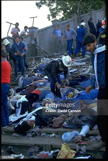 RESCUERS CHECK FOR SIGNS OF LIFE AMONGST THE BODIES LYING ON THE TERRACES OF THE HEYSEL STADIUM AFTER A WALL COLLAPSED KILLING 39 SUPPORTERS DURING A...
