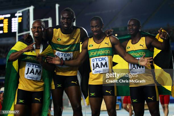 Michael Frater, Usain Bolt, Yohan Blake and Nesta Carter of Jamaica celebrate victory and a new world record in the men's 4x100 metres relay final...