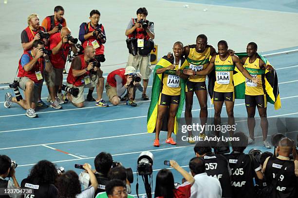 Michael Frater, Usain Bolt, Yohan Blake and Nesta Carter of Jamaica celebrate victory and a new world record in the men's 4x100 metres relay final...