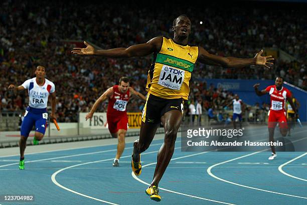 Usain Bolt of Jamaica celebrates victory and a new world record after crossing the finish line in the men's 4x100 metres relay final during day nine...