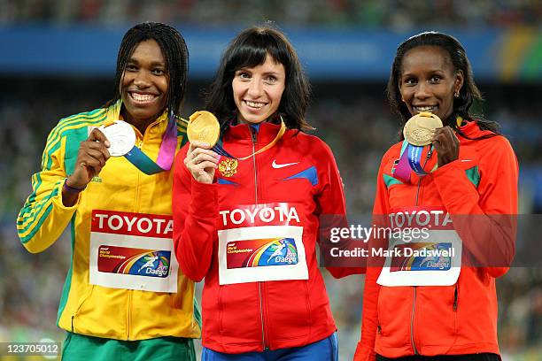 Mariya Savinova of Russia poses with her gold medal, Caster Semenya of South Africa the silver and Janeth Jepkosgei Busienei of Kenya the bronze...