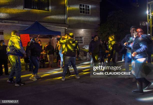 People dance in the street to the sound of Sonideros discs jockeys in Nezahualcoyotl, Mexico State, on December 4 following the return of street...