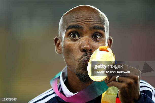 Mohamed Farah of Great Britain celebrates with his gold medal during the medal ceremony for the men's 5000 metres final during day nine of 13th IAAF...
