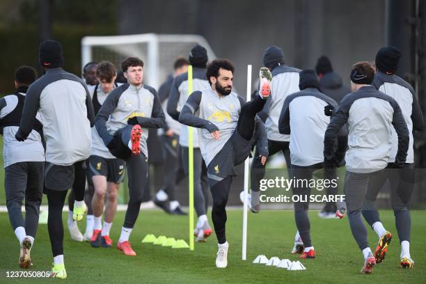 Liverpool's Egyptian midfielder Mohamed Salah warms up with teammates at their training ground in Kirkby, north of Liverpool in northwest England, on...