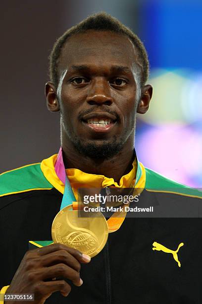Usain Bolt of Jamaica poses with his gold medal during the medal ceremony for the men's 200 metres final during day nine of 13th IAAF World Athletics...