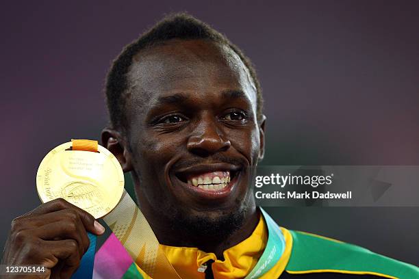 Usain Bolt of Jamaica poses with his gold medal during the medal ceremony for the men's 200 metres final during day nine of 13th IAAF World Athletics...