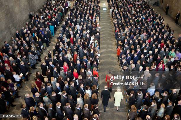 Britain's Queen Elizabeth II and Prince Philip, Duke of Edinburgh walk through a corridor lined with guests as they arrive for a Loyal Address...