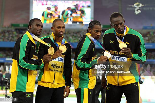 Nesta Carter, Michael Frater,Yohan Blake and Usain Bolt of Jamaica pose with their gold medals during the medal ceremony forthe men's 4x100 metres...