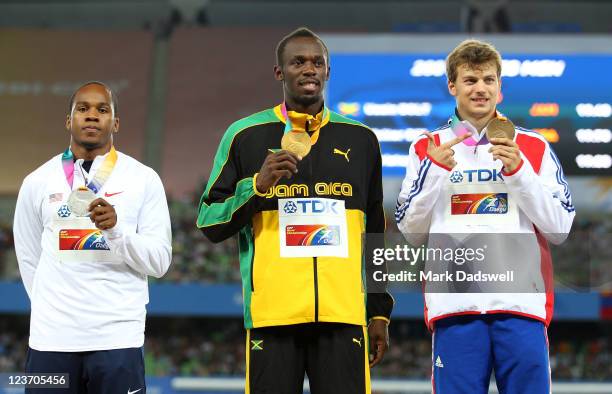 Usain Bolt of Jamaica poses with his gold medal, Walter Dix of the USA his silver and Christophe Lemaitre of France his bronze during the medal...