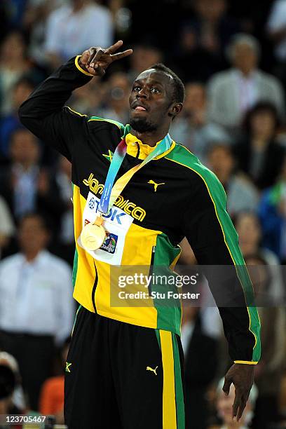 Usain Bolt of Jamaica poses with his gold medal during the medal ceremony for the men's 200 metres final during day nine of 13th IAAF World Athletics...