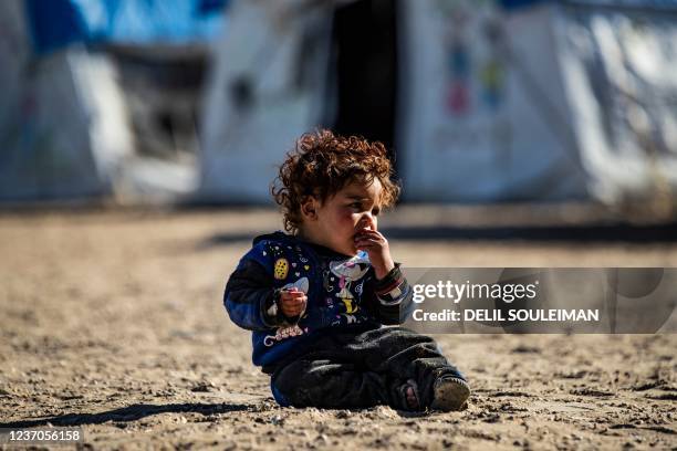 Picture shows a child sitting at the Kurdish-run al-Hol camp, which holds relatives of suspected Islamic State group fighters in the northeastern...