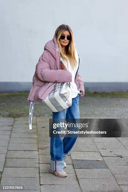 Influencer Gitta Banko wearing a multicolored knitted striped cardigan by Maiami, blue wide leg denim jeans pants by Tu Es Mon Tresor, a white...