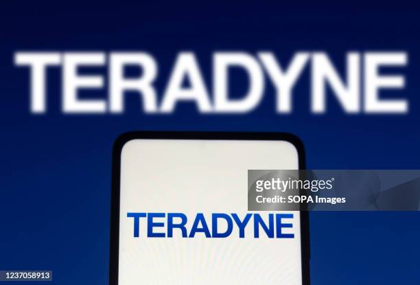 In this photo illustration the Teradyne logo seen displayed on a smartphone and on the background.
