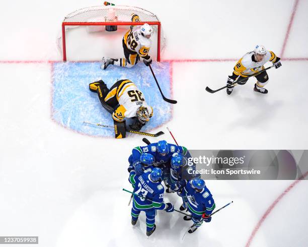 Vancouver Canucks right wing Vasily Podkolzin is congratulated after scoring a goal on Pittsburgh Penguins goaltender Tristan Jarry during their NHL...