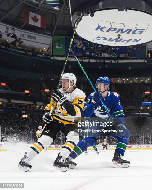 Vancouver Canucks defenseman Tyler Myers defends against Pittsburgh Penguins left wing Jake Guentzel during their NHL game at Rogers Arena on...