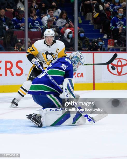 Pittsburgh Penguins center Sidney Crosby watches Vancouver Canucks goaltender Thatcher Demko make a save during their NHL game at Rogers Arena on...