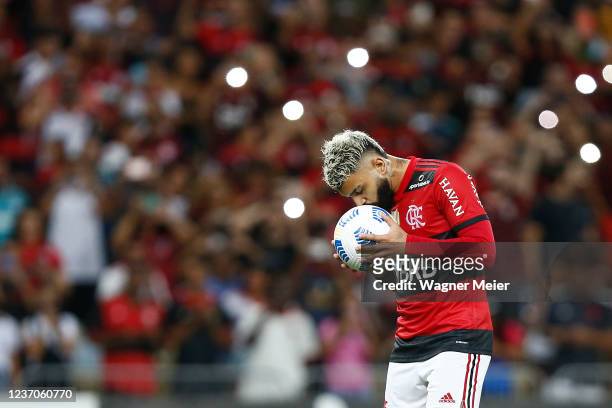Gabriel Barbosa of Flamengo kisses the ball before a penalty kick during a match between Flamengo and Santos as part of Brasileirao 2021 at Maracana...